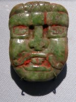 Carved jade pendant showing the face of the Sun God, K’inich Ajaw, 475-500 CE, Honduras, Copan. (U of Pennsylvania Museum, Philadelphia)